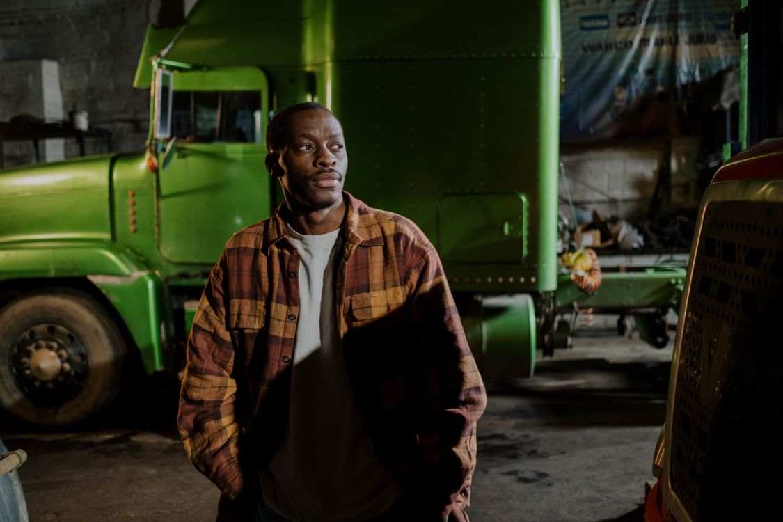 Truck driver beside an American conventional semi-truck
